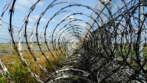 https://pixabay.com/en/prison-fence-razor-ribbon-wire-218456/ Border fence