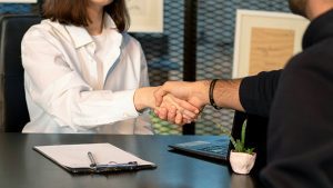 Litigation vs Settlement: Resolving Business Disputes Commercially and Efficiently - Image credit - Photo by Mina Rad on Unsplash https://unsplash.com/photos/a-man-and-a-woman-shaking-hands-in-front-of-a-laptop-qFSQFSmfZkA 